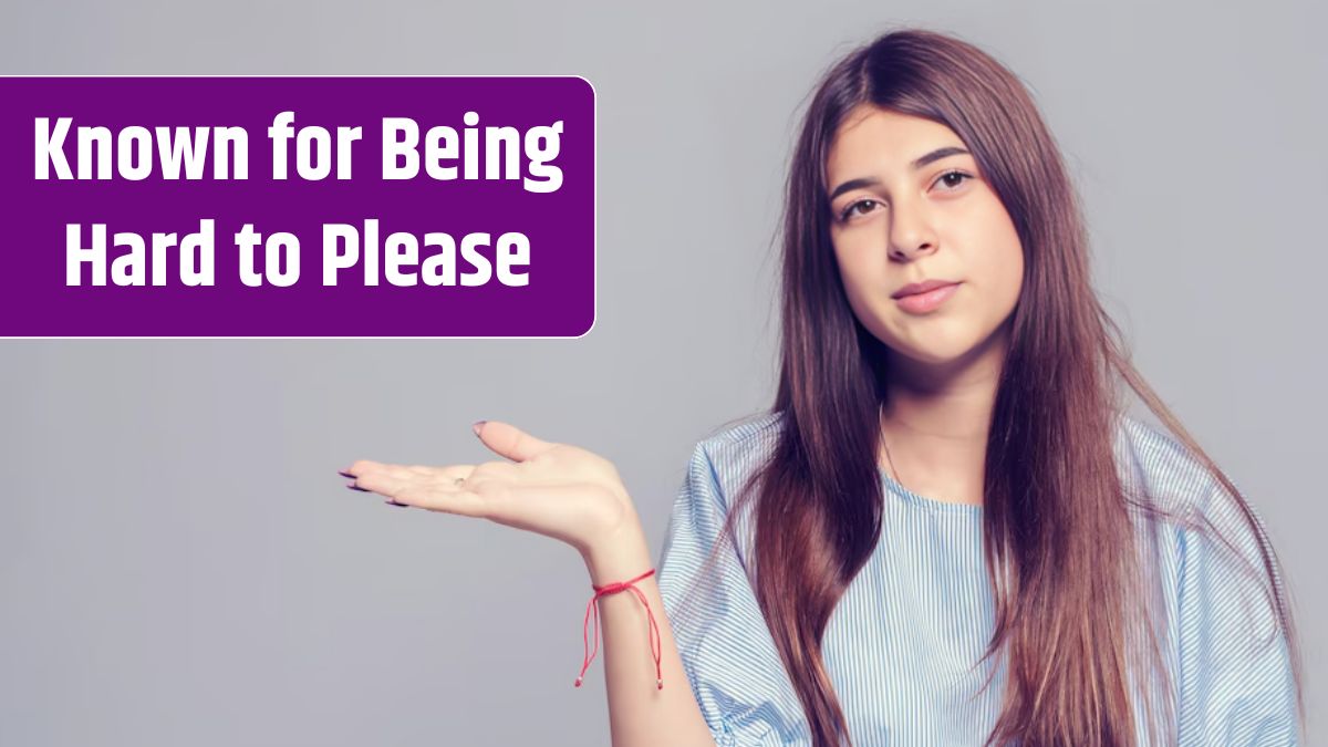 Girl with thick eyebrows and long dark hair holding her palm.