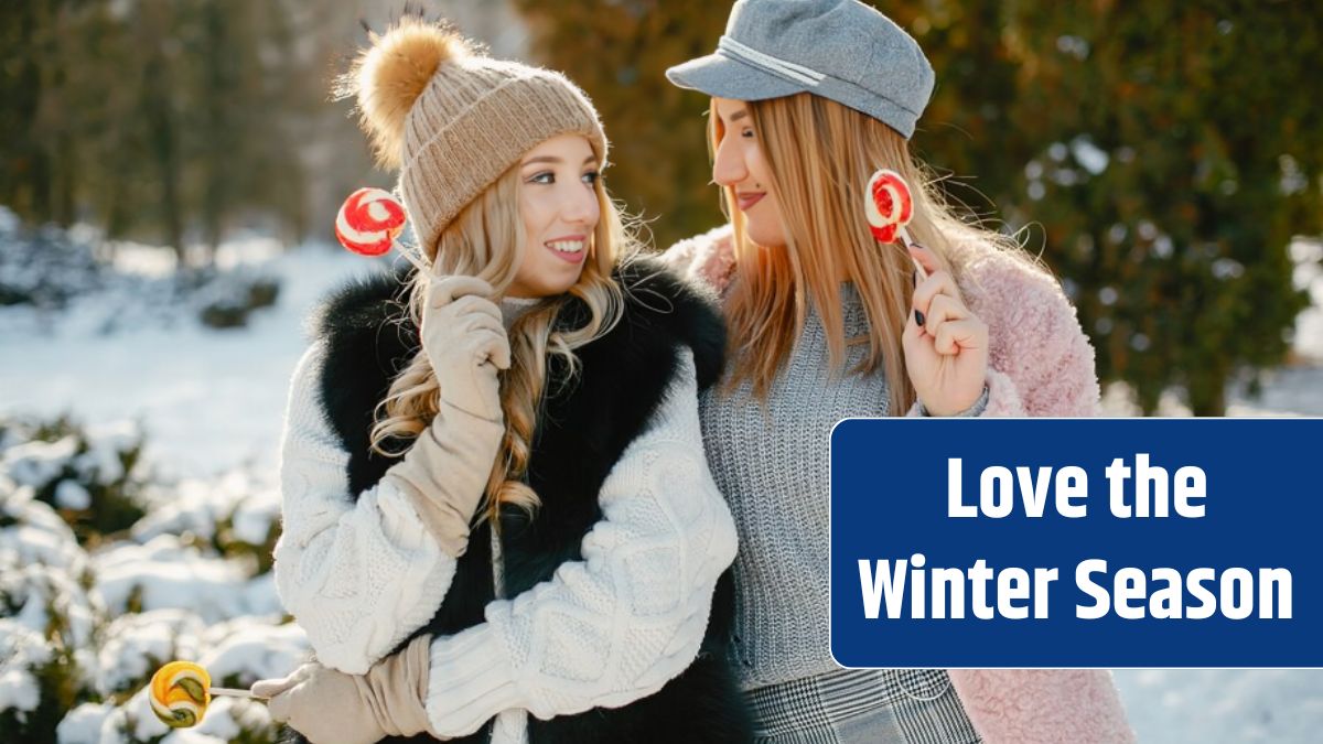 Young and stylish girls in the winter clothes are walking in the solar park with candyes.